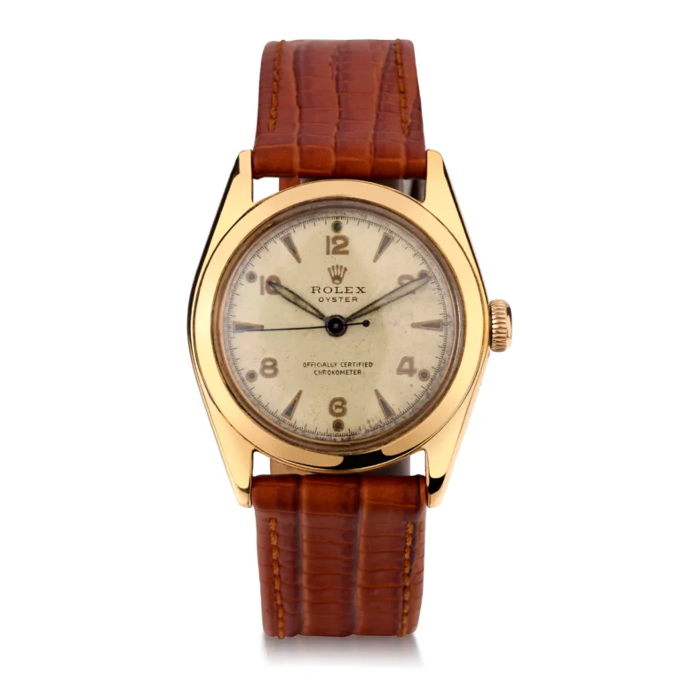 Gold Rolex Oyster 5020 watch with a brown leather strap and a white dial featuring Arabic numerals and markers.