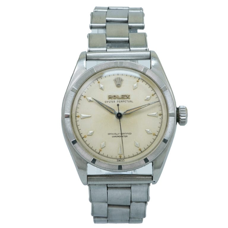 A vintage silver Rolex Oyster Perpetual 6103 wristwatch with a cream dial and metal bracelet.