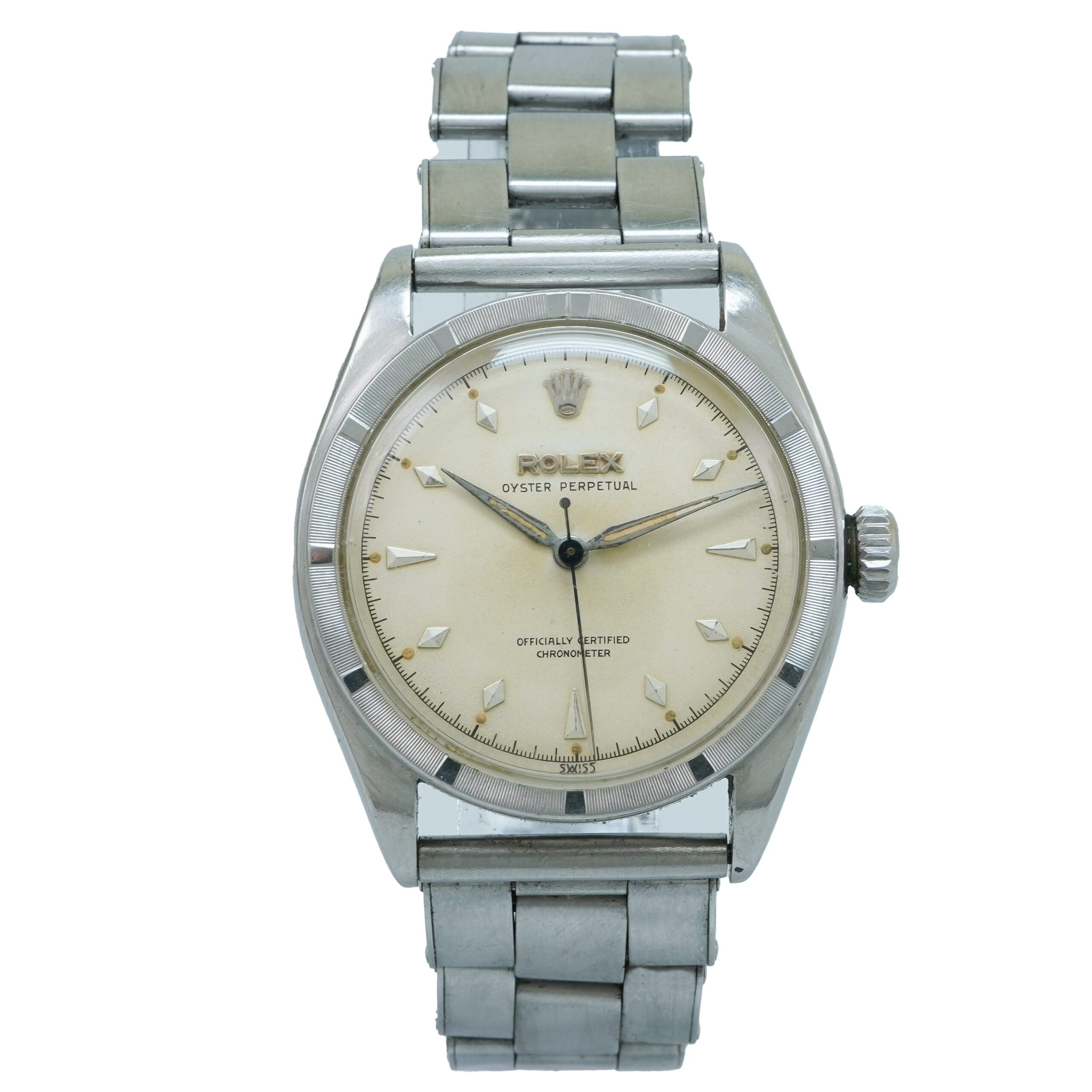 A vintage silver Rolex Oyster Perpetual 6103 wristwatch with a cream dial and metal bracelet.
