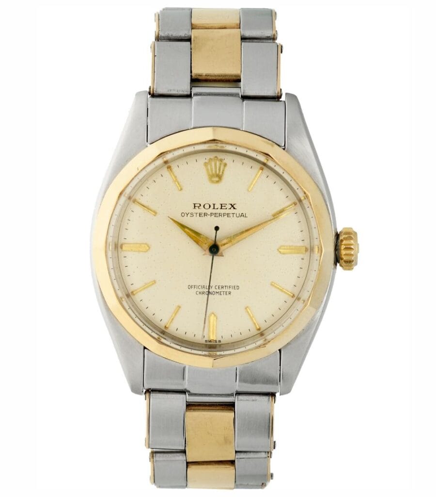 A silver and gold Rolex Oyster Perpetual 6586 wristwatch with a white dial and metal bracelet.