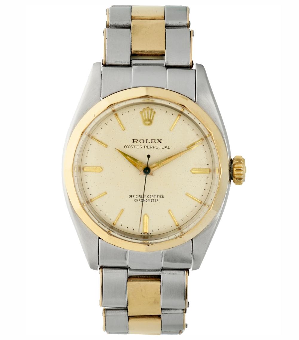 A silver and gold Rolex Oyster Perpetual 6586 wristwatch with a white dial and metal bracelet.