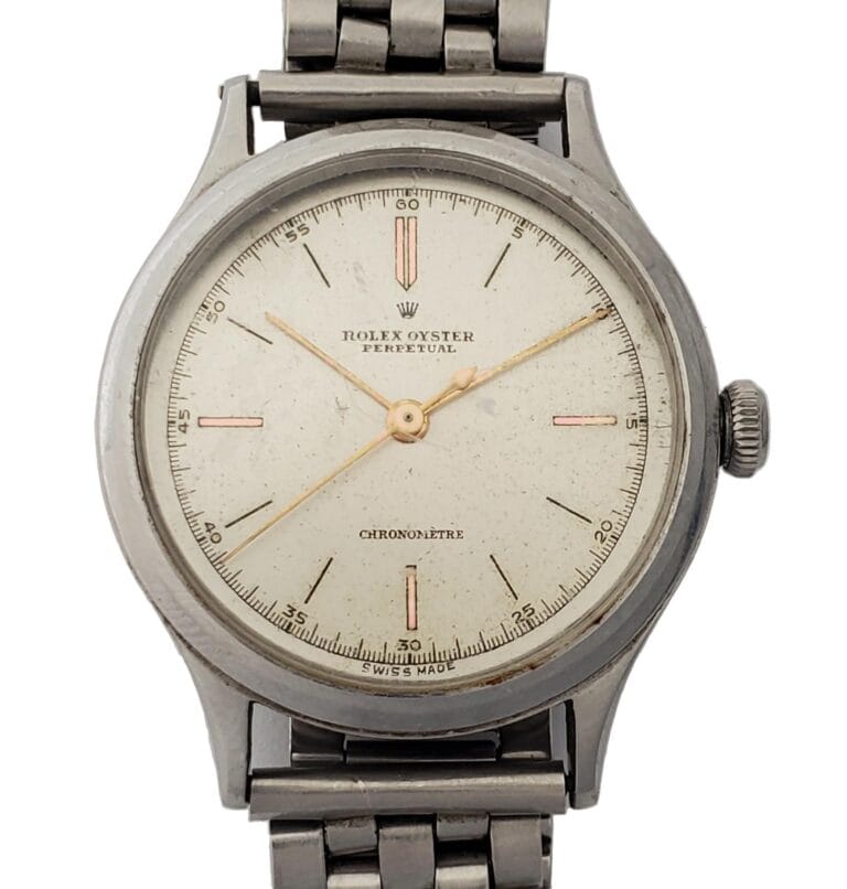 Vintage Rolex Oyster Perpetual 4362 wristwatch featuring a metal band and a simple white dial.
