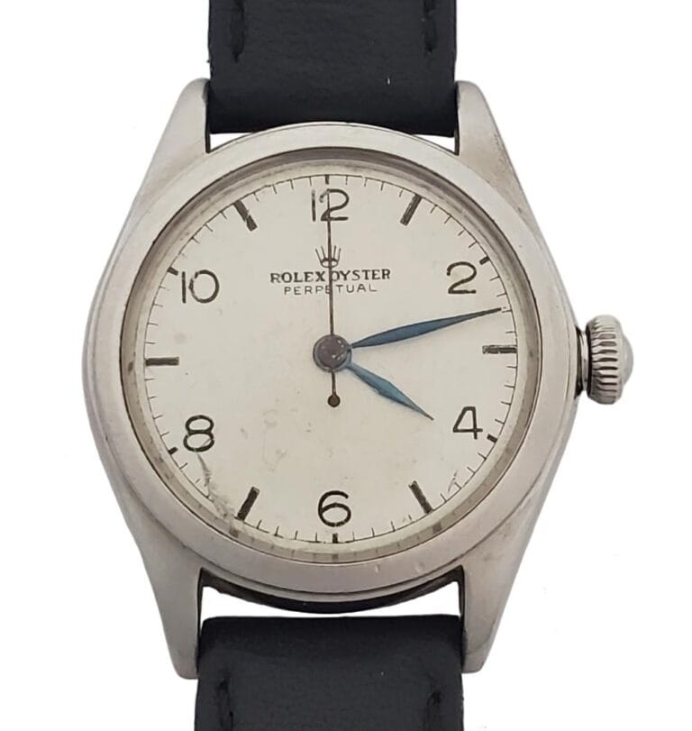 Vintage Rolex Oyster Perpetual 4846 watch featuring a white dial, black numerals, and a classic black leather strap.