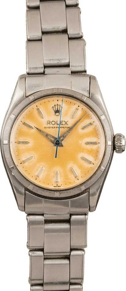 Silver Rolex Oyster Perpetual 6549 wristwatch with a cream-colored face and silver hour markers and band.