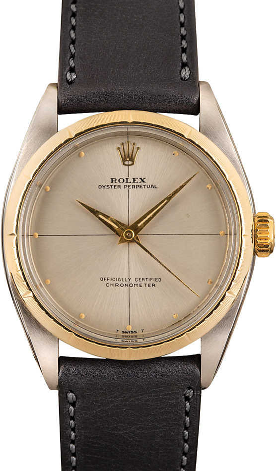 A Rolex Oyster Perpetual 6592 watch featuring a gold bezel, silver dial, and black leather strap.