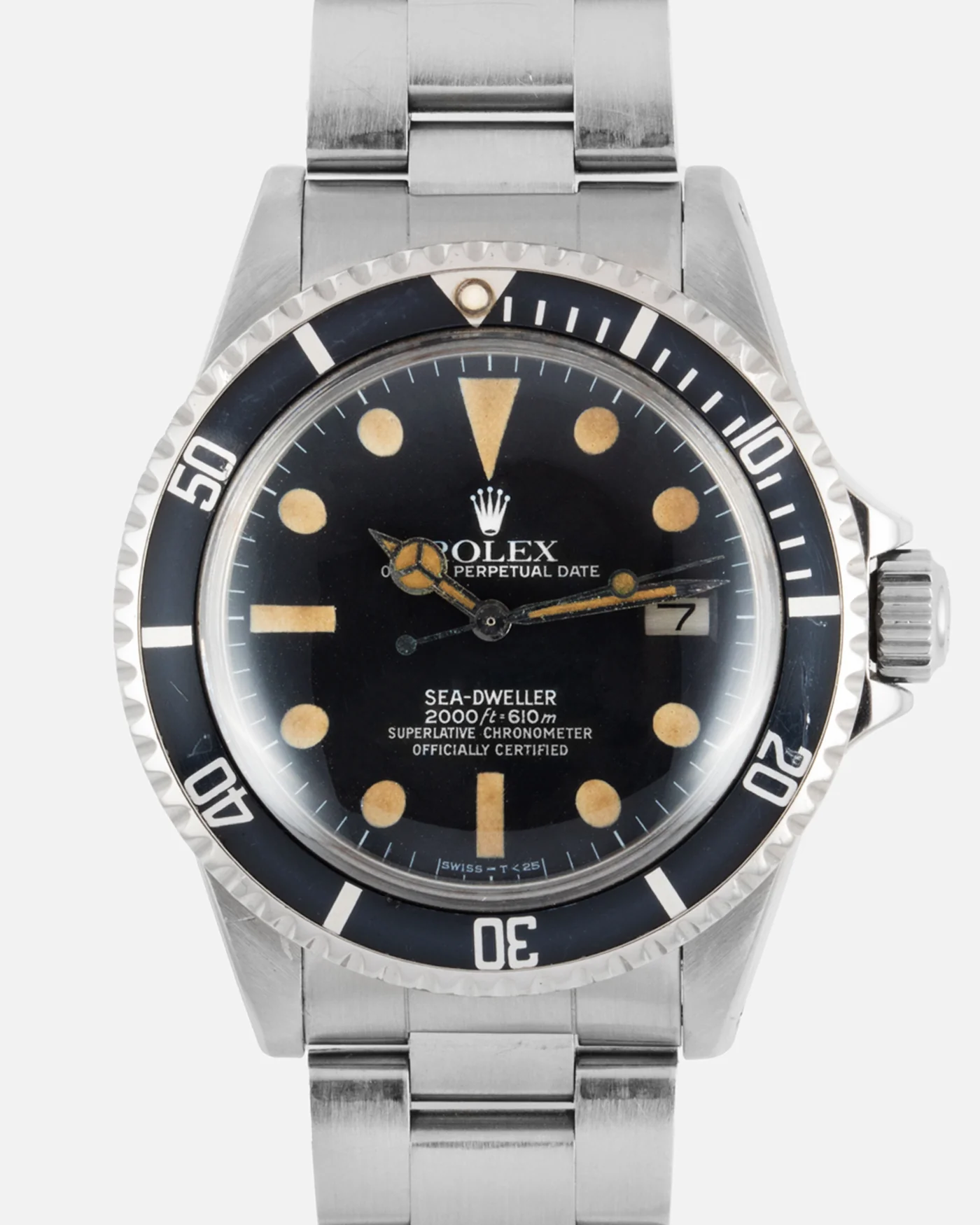 A vintage Rolex Sea-Dweller 1665 watch featuring a black dial, date window, and stainless steel band.