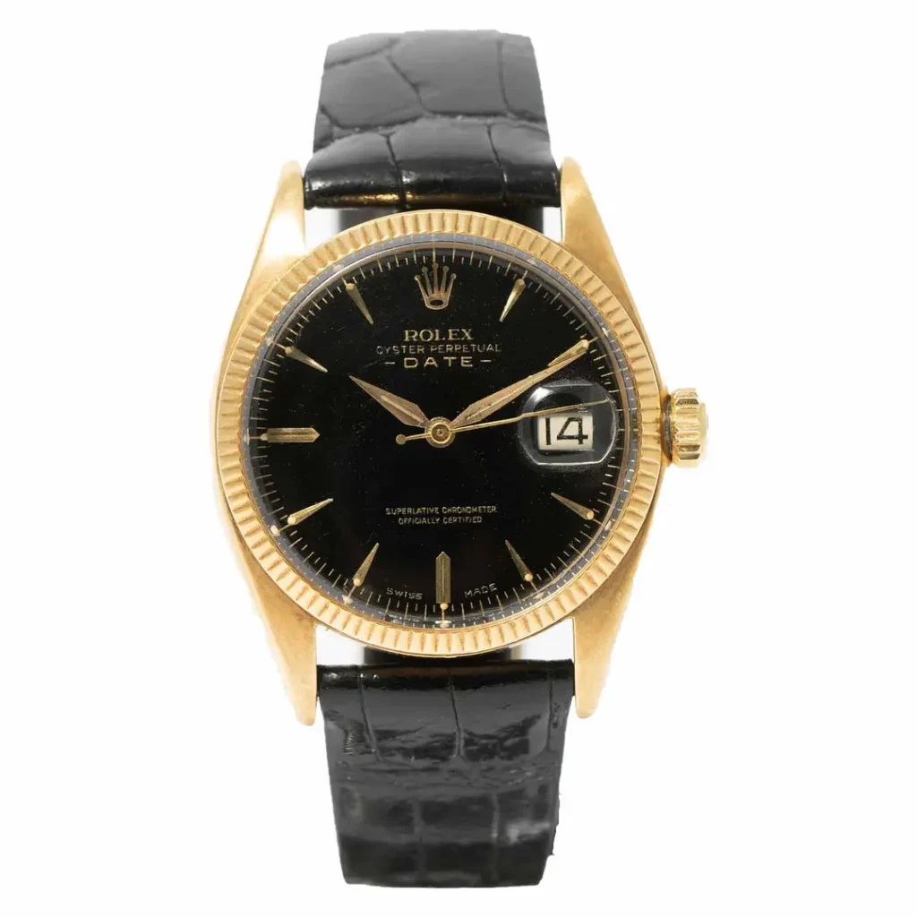 Gold Rolex Oyster Perpetual watch with a black dial, date display, and black leather strap, shown from the front.