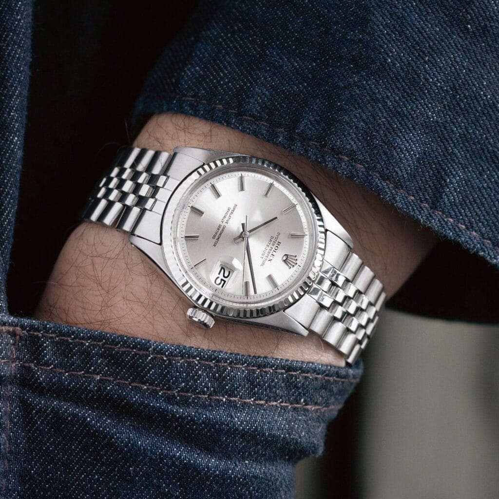 a silver Rolex datejust 1601 watch on a person's arm