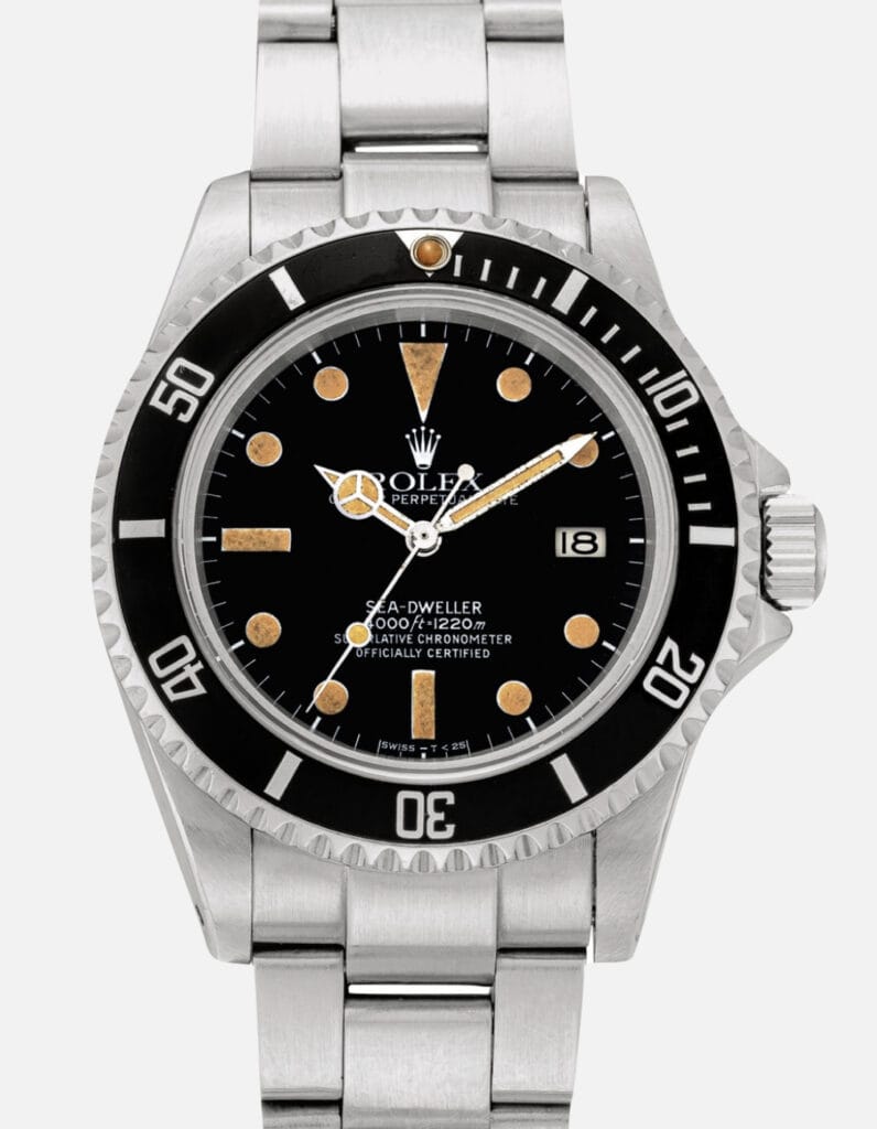A vintage stainless steel Rolex Sea-Dweller 16660 watch featuring a black dial, date window, and rotating bezel.
