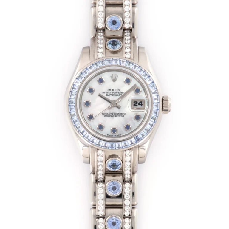 A silver Rolex Datejust 80309 watch featuring diamond and blue gemstone accents, complete with a sleek date display.