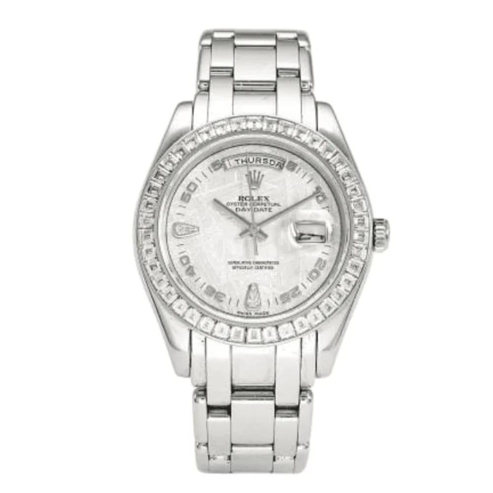 A luxury watch, this silver Rolex Day-Date features a diamond bezel and day-date display on a sleek metal link band.
