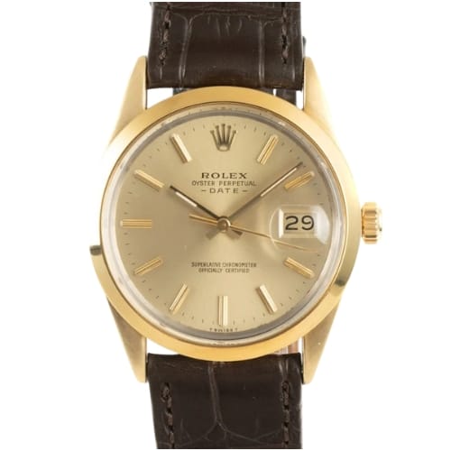 Gold Rolex Oyster Perpetual wristwatch with a brown leather strap, date display at 3 oclock, and a champagne dial—classic elegance from the iconic Date 15505 series.