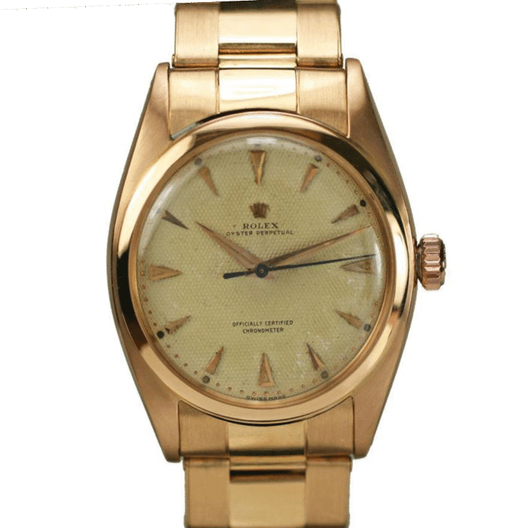 A vintage gold Rolex Oyster Perpetual 6088 wristwatch with a champagne-colored dial and elegant gold hour markers.