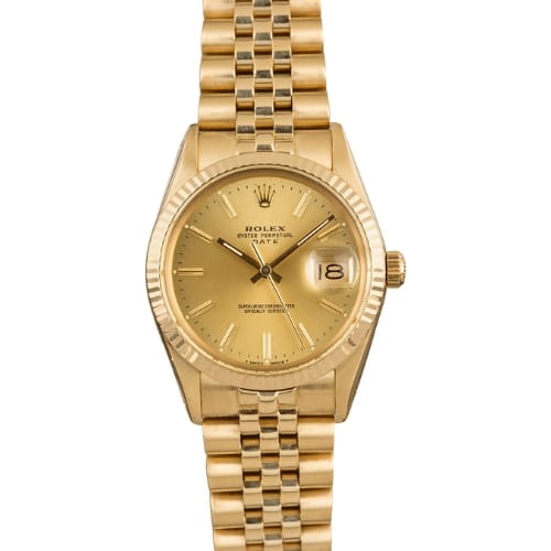 Gold Rolex Oyster Perpetual Date wristwatch featuring a link band, gold face, and date display at the 3 o’clock position.