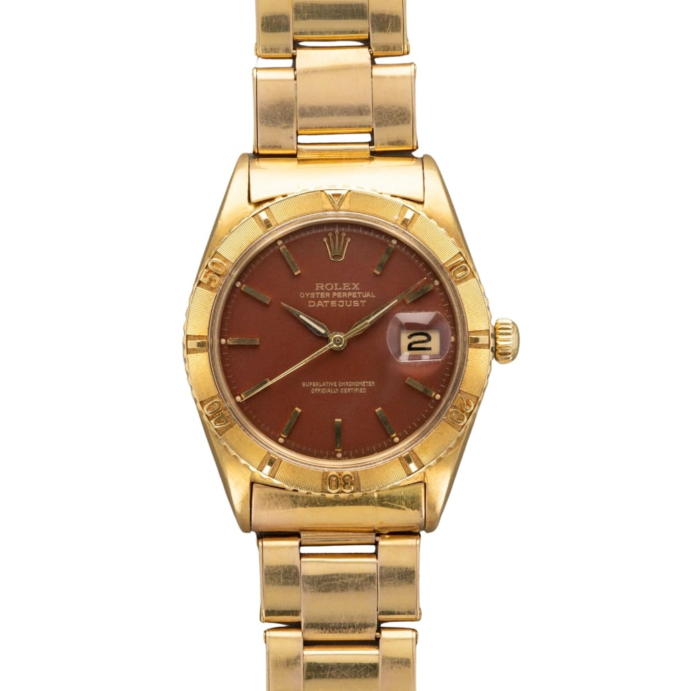 Gold Rolex Oyster Perpetual wristwatch with a brown dial and date display, featuring a gold metal band and bezel. Classic design reminiscent of the renowned Date 1625 model.