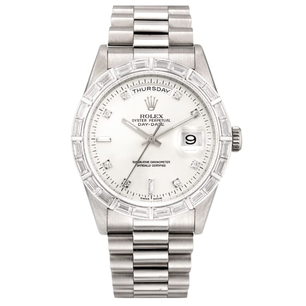 A silver Rolex Day-Date President 18369 watch with a white face, diamond bezel, metal band, and date and day displays.