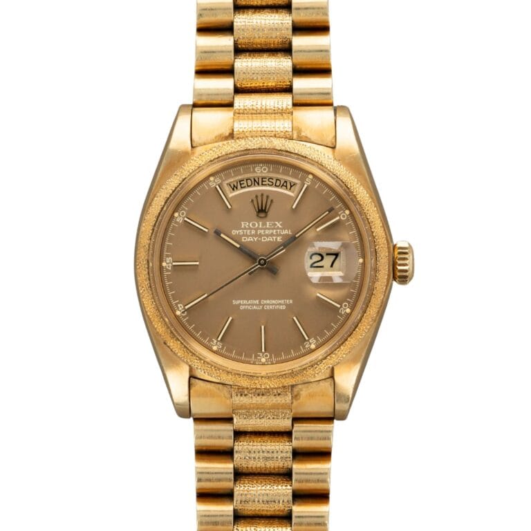A gold Rolex President wristwatch displaying Wednesday and the 27th, featuring a brown dial and gold bracelet.