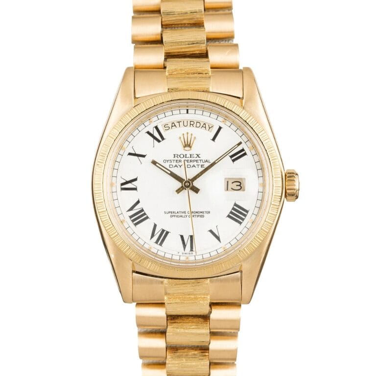 Gold Rolex Day-Date President 1807 watch with a white dial, Roman numerals, and day and date display on a gold bracelet.