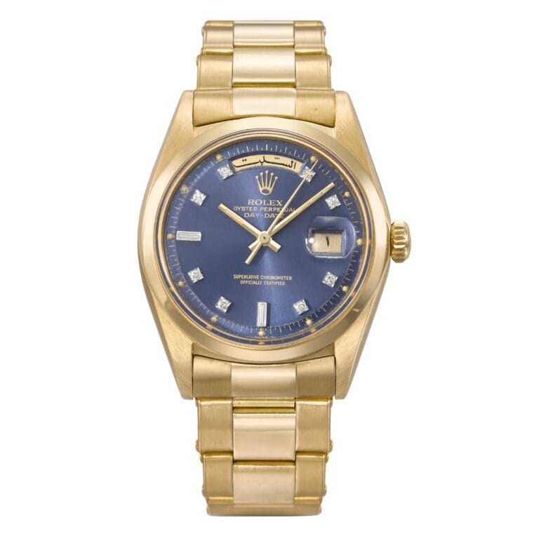 Gold Rolex Day-Date watch with a blue face, diamond hour markers, and a date display on a gold metal band—the epitome of the iconic Rolex President style.