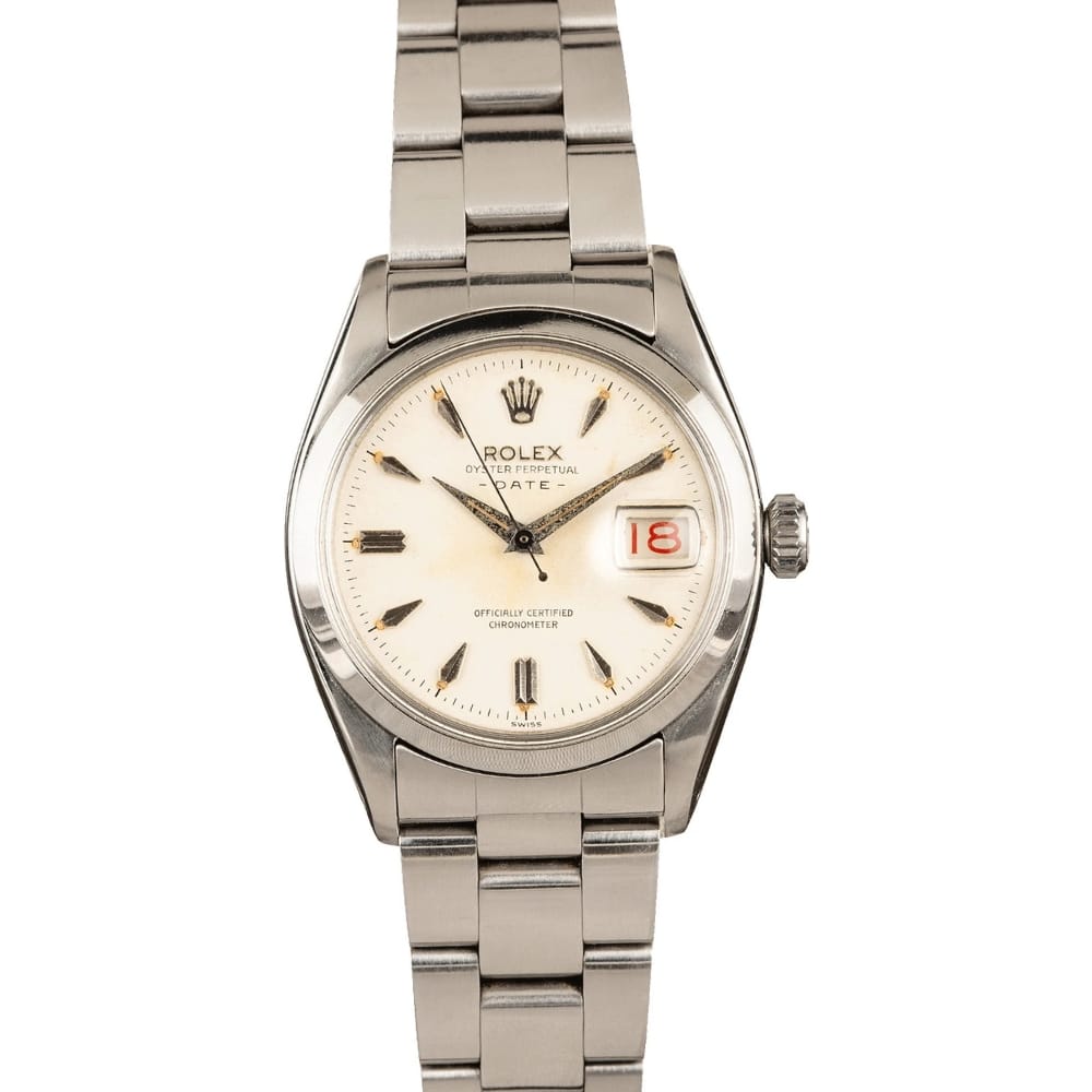 A silver Rolex Oyster Perpetual Date 6534 watch featuring a white dial and a date display at 3 oclock.