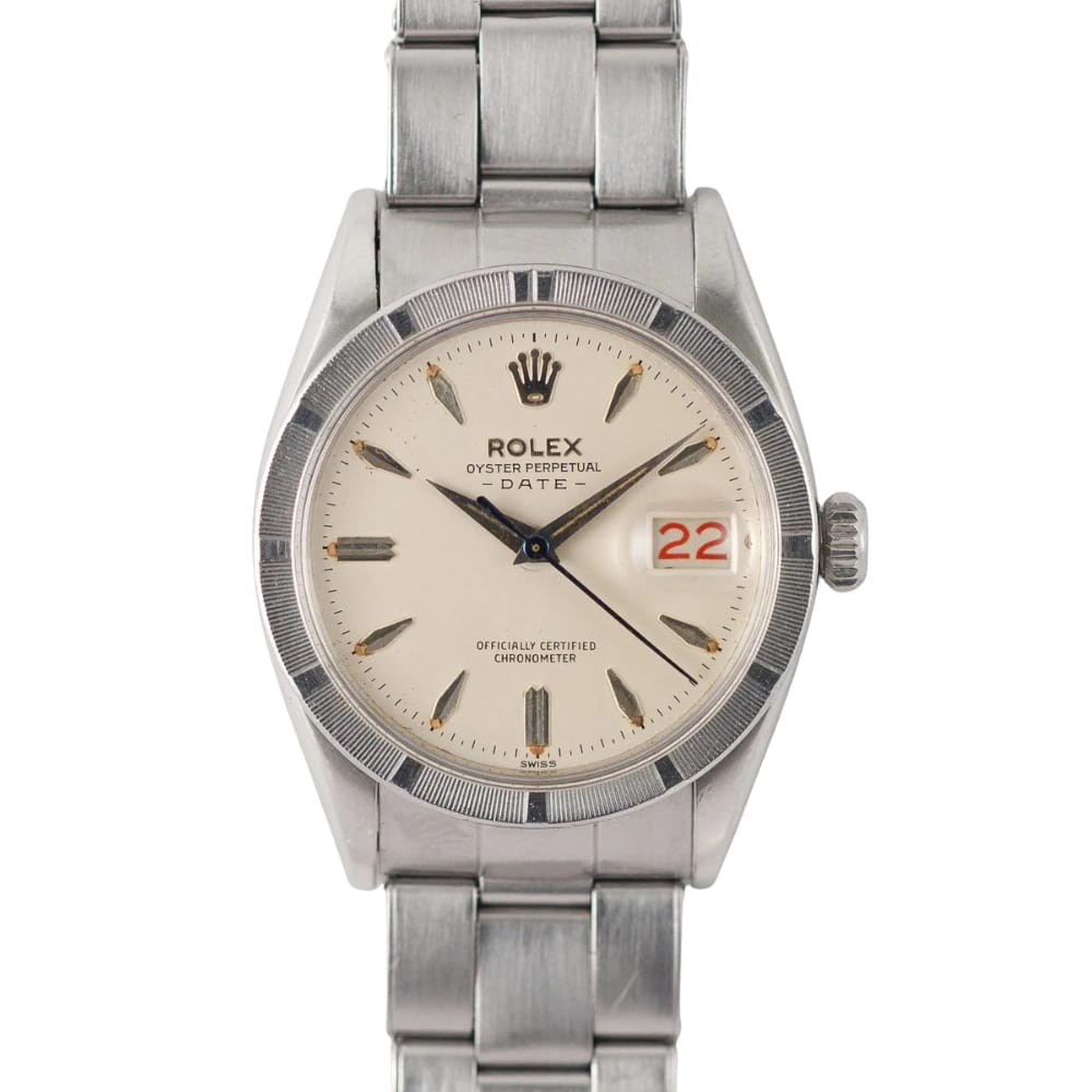 A stainless steel Rolex Oyster Perpetual Date 6535 watch featuring a white dial and a striking red 22 on the date display.