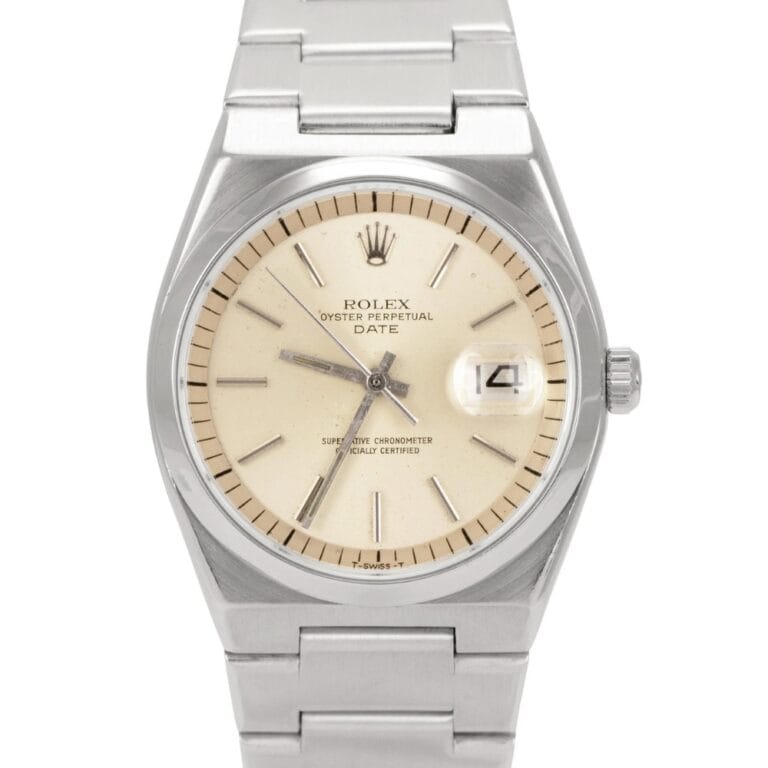 A silver Rolex Oyster Perpetual Date 1530 watch with a cream dial and a metal link bracelet.
