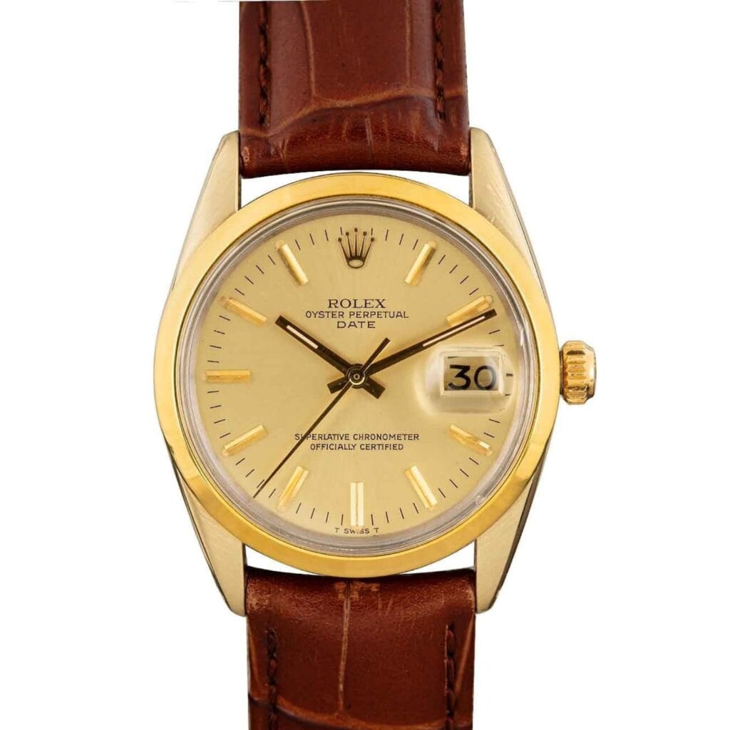 Gold Rolex Oyster Perpetual Date 1550 watch featuring a brown leather strap, cream dial, and date window displaying 30.