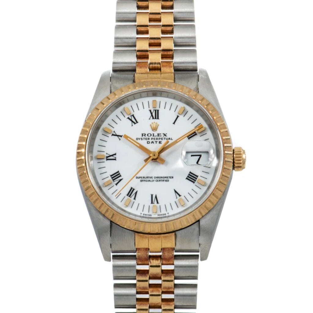 Rolex Oyster Perpetual watch with a gold and silver band, white face, Roman numerals, and a date display at 3 oclock.
