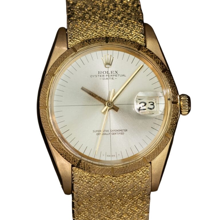 Gold Rolex Oyster Perpetual Date 1510 watch with a textured band and the date set to 23.