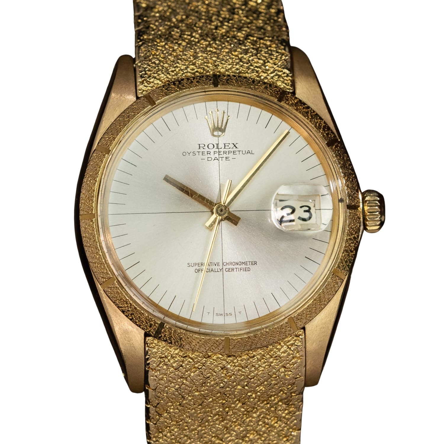 Gold Rolex Oyster Perpetual Date 1510 watch with a textured band and the date set to 23.