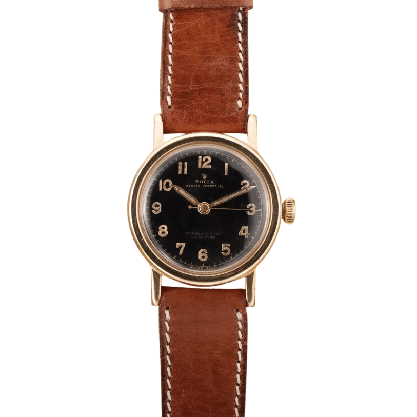 A vintage Rolex Oyster Perpetual wristwatch with a black dial, gold case, and brown leather strap.