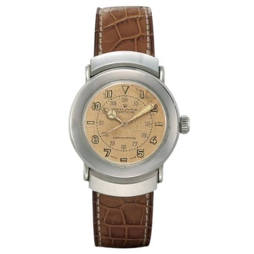 A vintage Rolex Oyster Perpetual 3536 wristwatch with a brown leather strap and a beige dial featuring Arabic numerals.