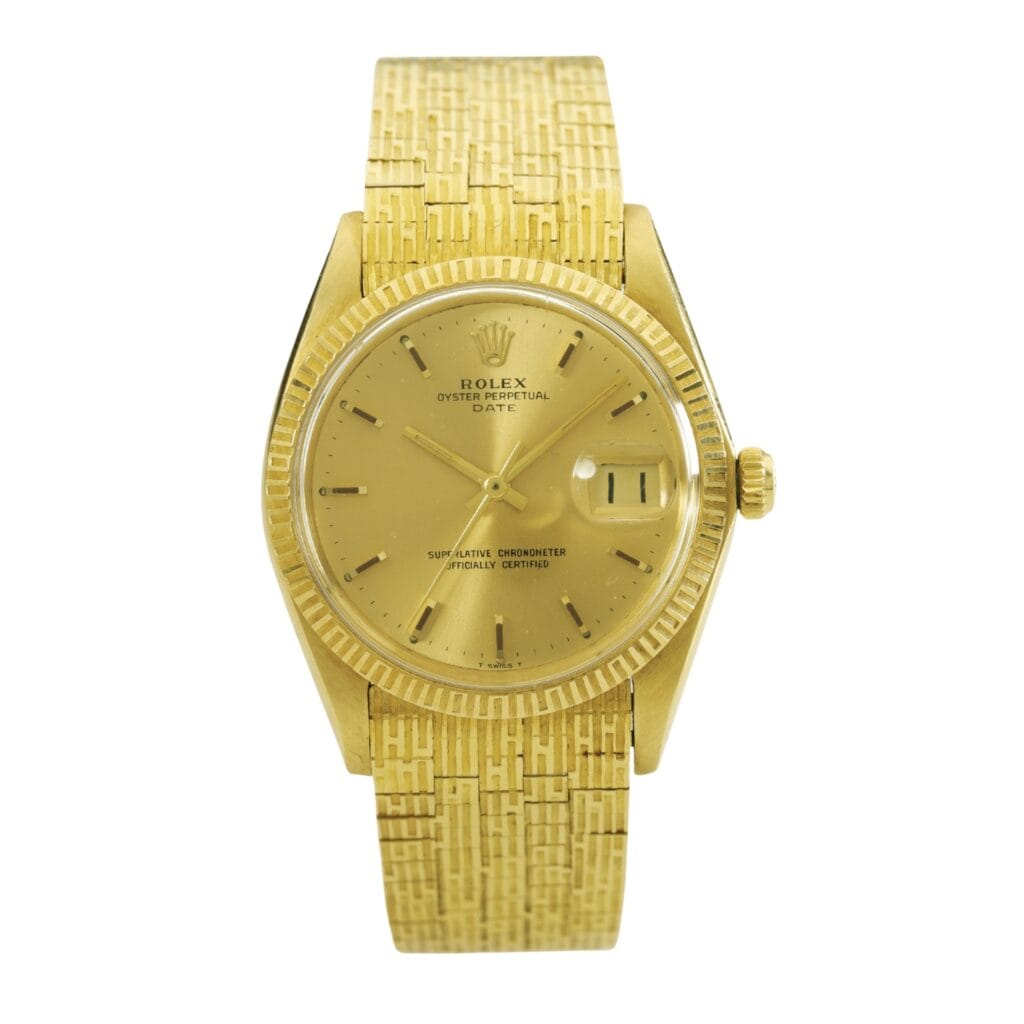 Gold Rolex Oyster Perpetual Date 1509 wristwatch featuring a textured gold band and a date display on the right side of the dial.