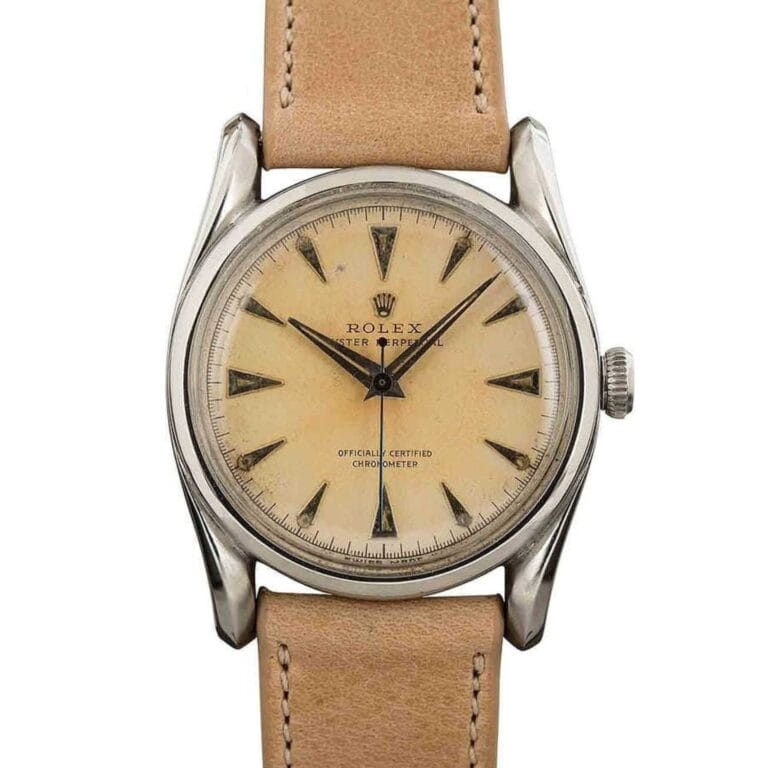 Vintage Rolex Oyster Perpetual 1508 wristwatch featuring a tan leather strap and cream dial with elegant silver hour markers and hands.