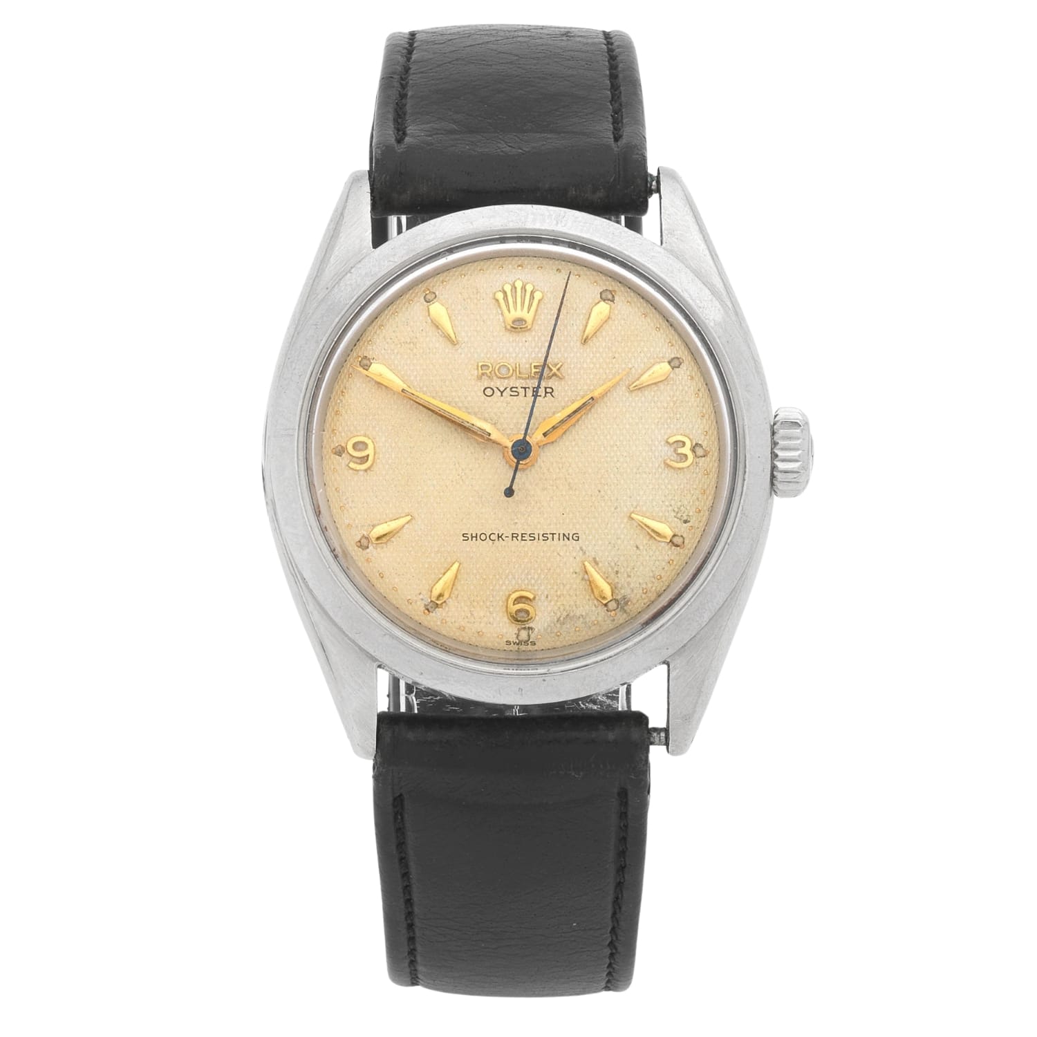 Vintage Rolex Oyster 6480 watch with a cream dial, gold hour markers, and a black leather strap.
