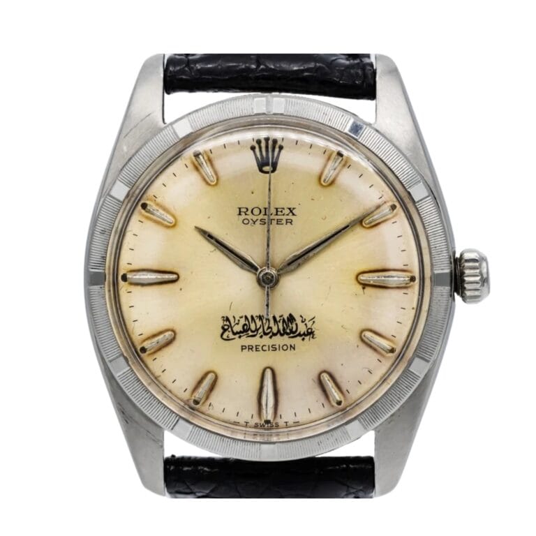 A vintage Rolex Oyster Precision watch with Arabic script on a cream dial and a black leather strap, this classic timepiece is a fine example of the sought-after Rolex 6425 model.