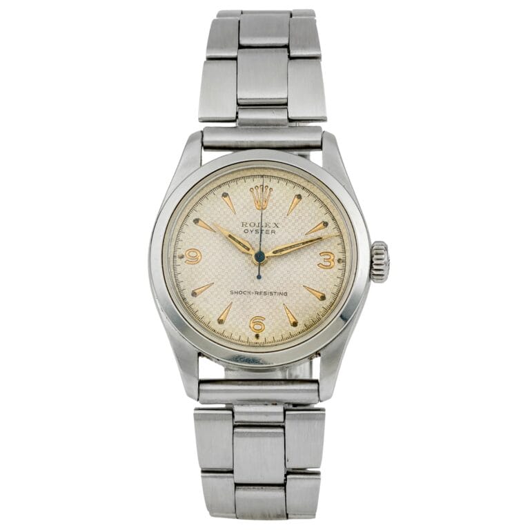 A vintage Rolex Oyster wristwatch with a stainless steel band and a cream-colored dial, this classic timepiece embodies the timeless elegance of the iconic Rolex 6244 model.