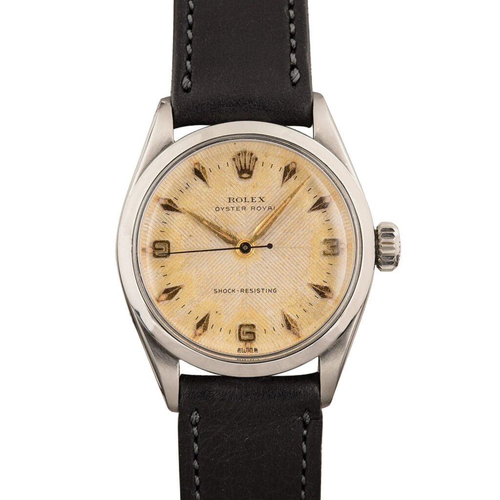 Rolex Oyster Royal 6246 watch with a cream textured dial, black indices, and a black leather strap.
