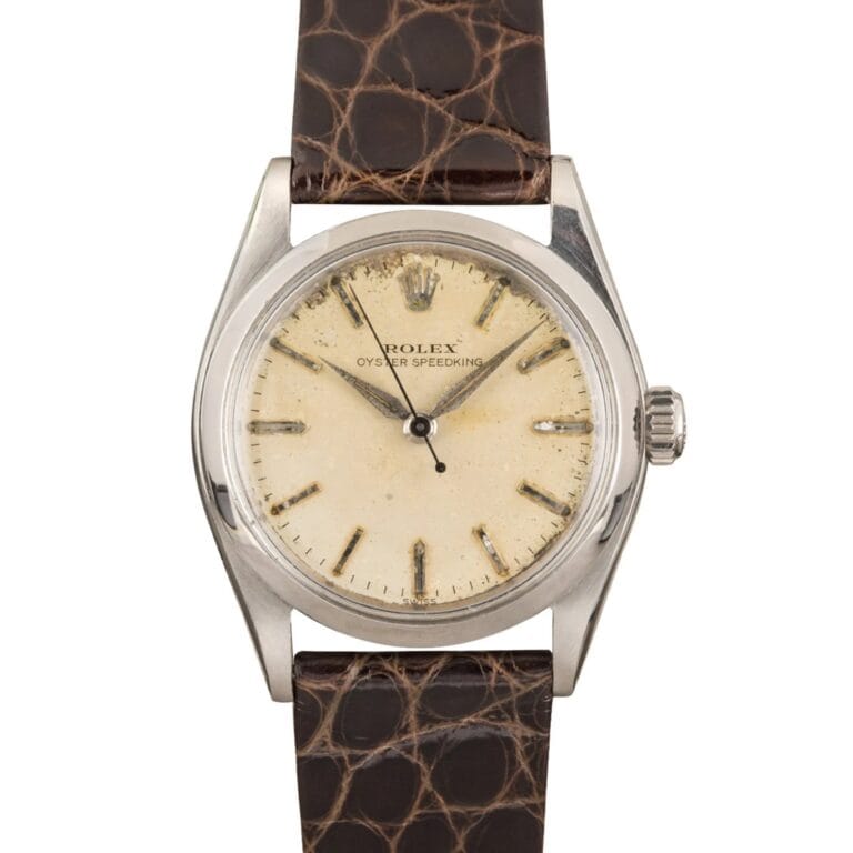 Vintage Rolex Oyster Speedking 6420 watch featuring a cream dial, silver case, and brown leather strap.