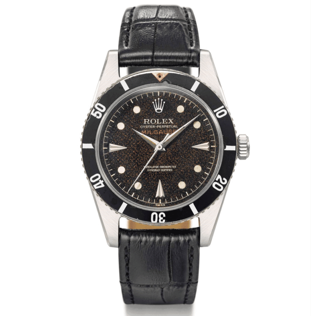 A vintage Rolex Oyster Perpetual Milgauss 6543 watch with a black dial, black bezel, and black leather strap.
