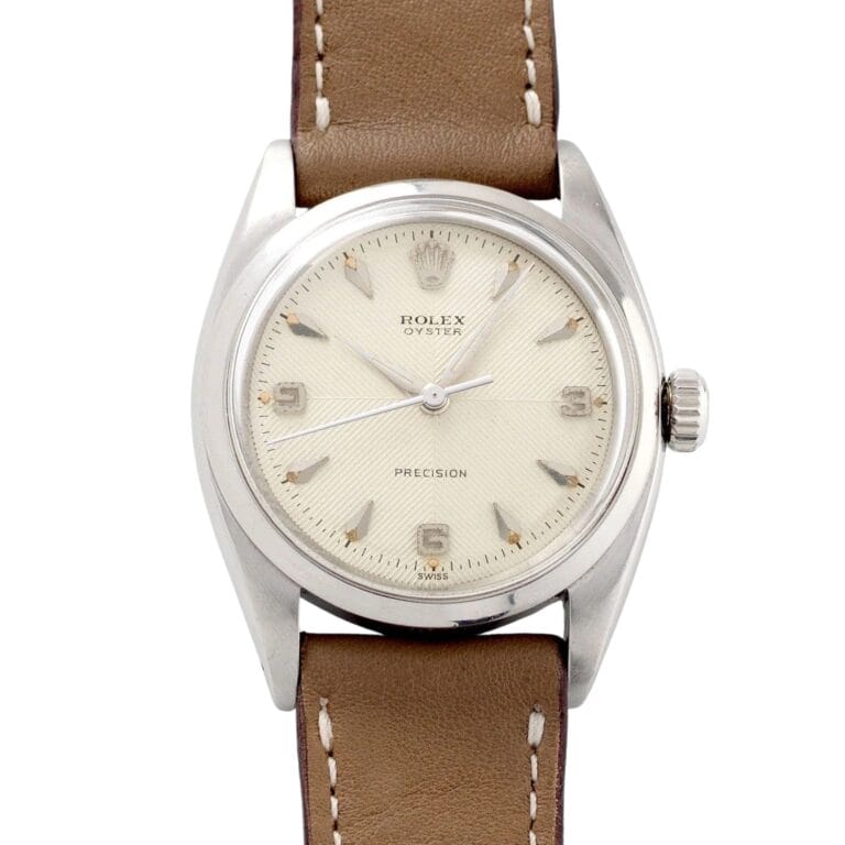 A vintage Rolex Oyster Precision watch, model Rolex 6422, featuring a beige dial and classic brown leather strap.