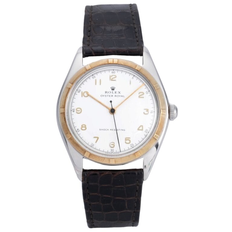 A Rolex Oyster Royal 5025 watch featuring a white dial, gold bezel, and black leather strap.