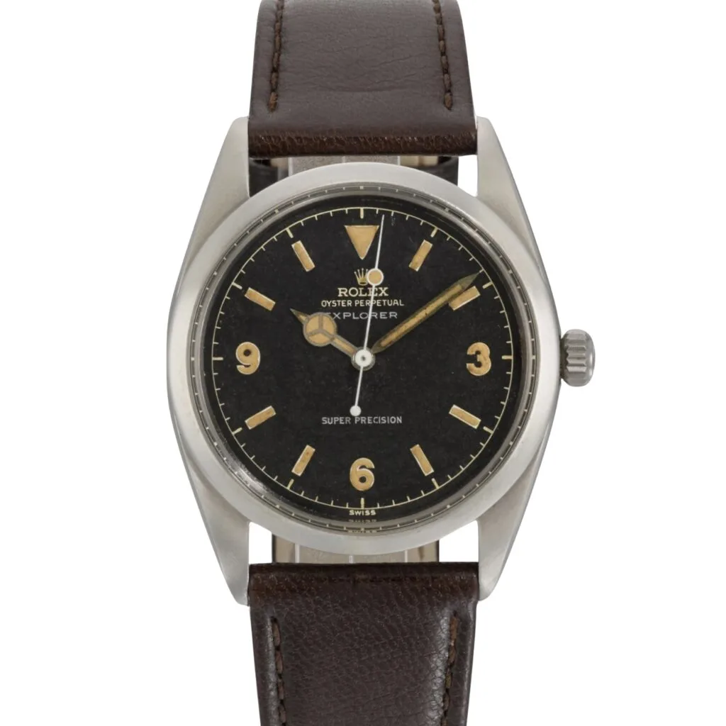 Vintage Rolex Explorer watch with a black dial, gold hour markers, and a brown leather strap—an iconic Rolex piece for collectors.