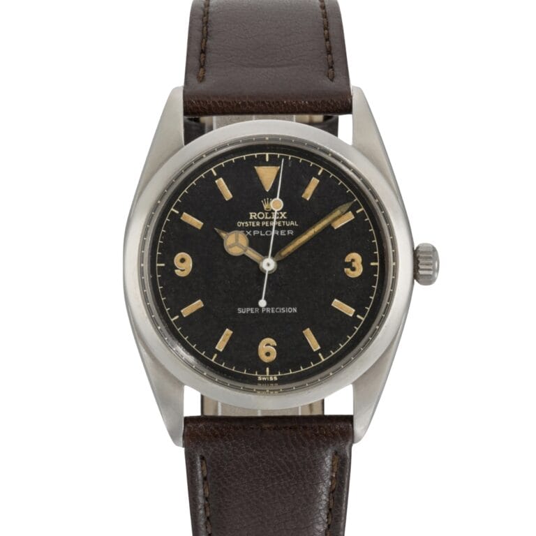 Vintage Rolex Explorer watch with a black dial, gold hour markers, and a brown leather strap—an iconic Rolex piece for collectors.