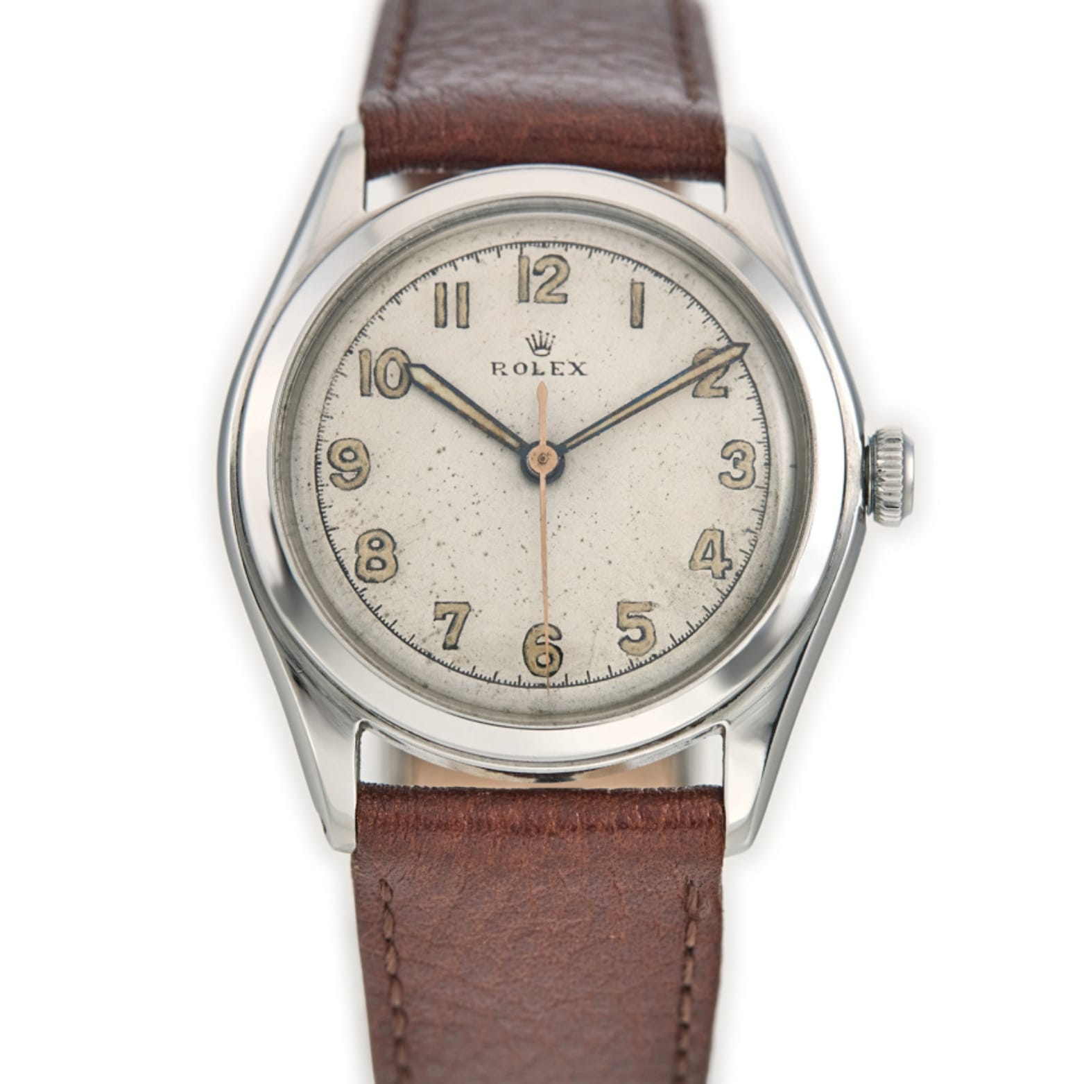 A vintage Rolex Oyster 4499 wristwatch with a brown leather strap and a silver dial displaying Arabic numerals.