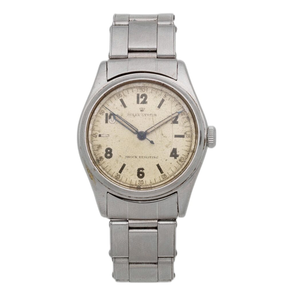 A vintage stainless steel Rolex Oyster 4444 wristwatch with a cream-colored dial and black numerals.