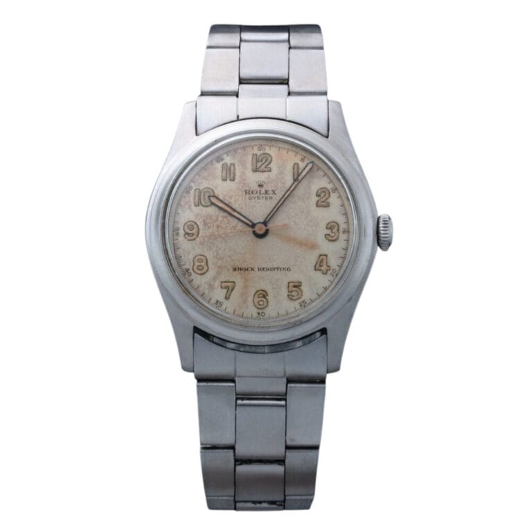A vintage Rolex Oyster 4361 wristwatch with a metal band and an aged, off-white dial displaying Arabic numerals.