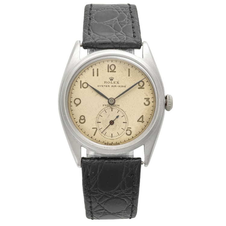 Vintage Rolex Oyster Air-King watch featuring a cream dial, black numerals, and a black leather strap—classic style reminiscent of the iconic Rolex Oyster 4365.