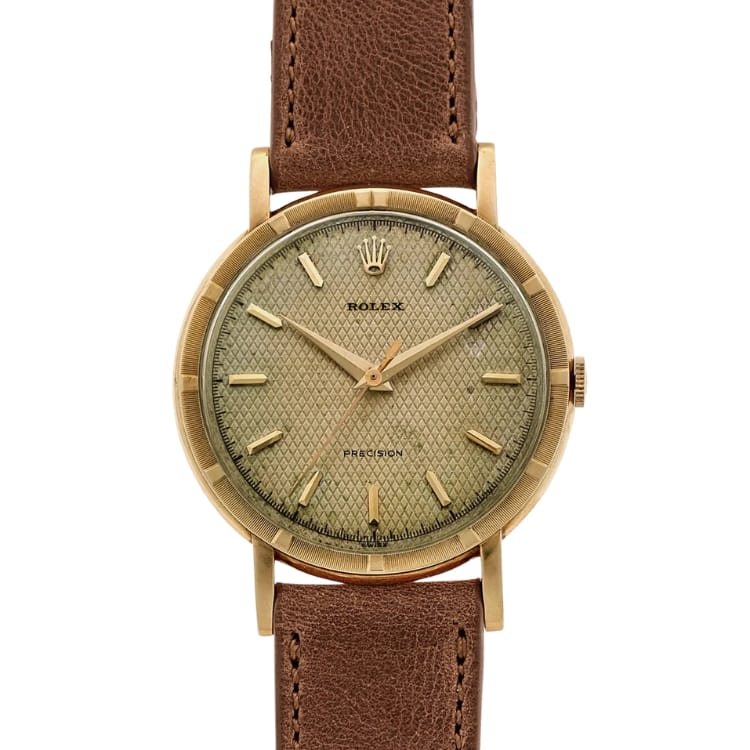 A vintage Rolex Precision watch with a textured dial and brown leather strap, model Rolex 4448, displayed on a white background.
