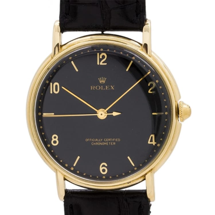 Gold Rolex Precision 4222 wristwatch with a black face, gold hour markers, and a black leather strap, showing 10:10 time.